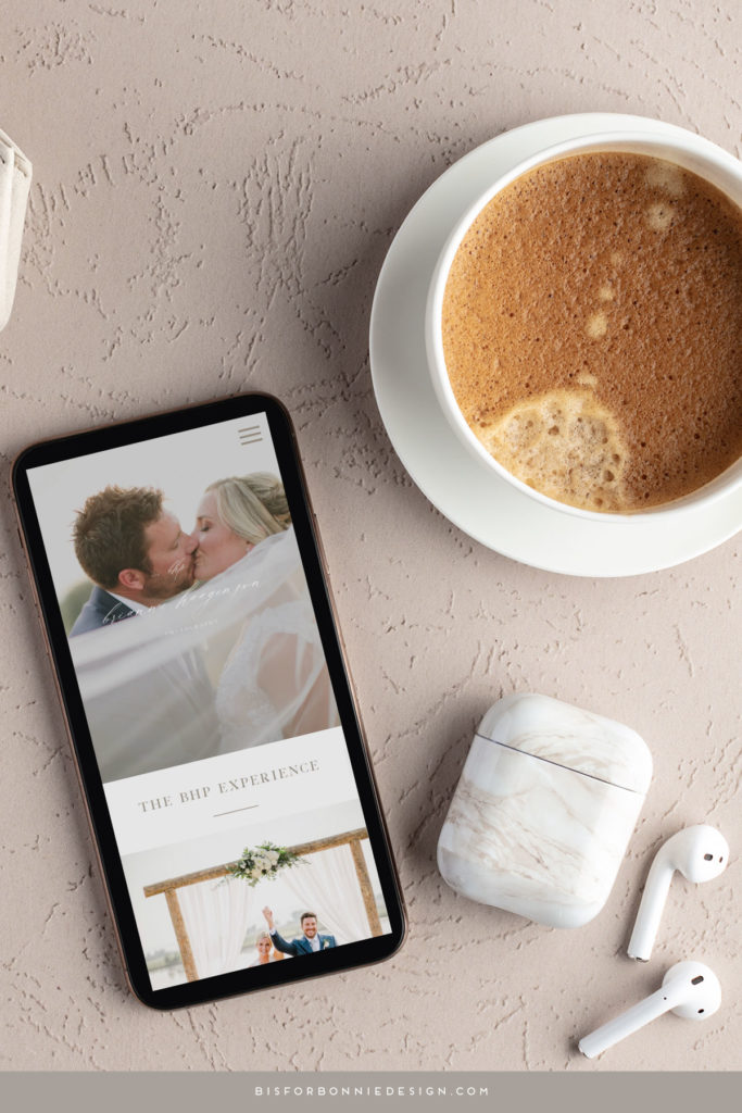 A cup of coffee and airpods sit next to a phone, which is displaying Brianne Haagenson Photography's new website design.